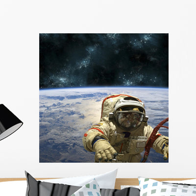Cosmonaut Floats Space Wall Decal shown on a wall