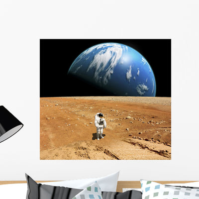 Astronaut Standing Barren World Wall Decal shown on a wall