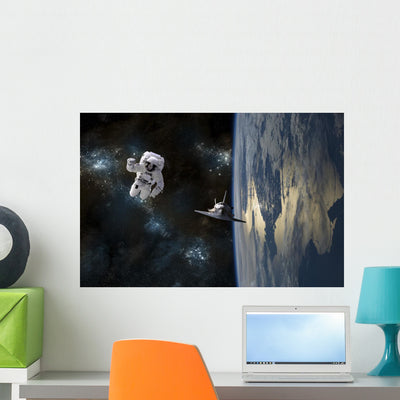Astronaut Drifting Space Is Wall Decal shown on a wall