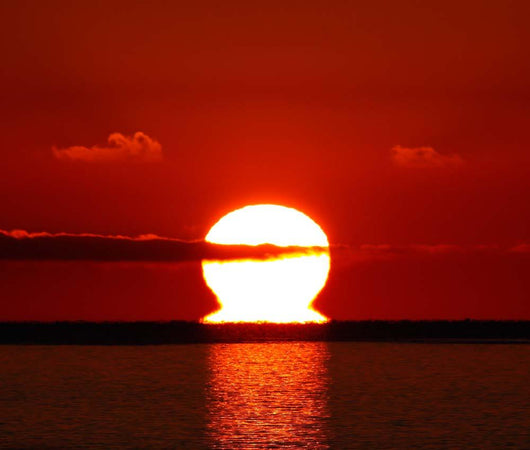 Omega-shaped Sunrise above Water Wall Decal