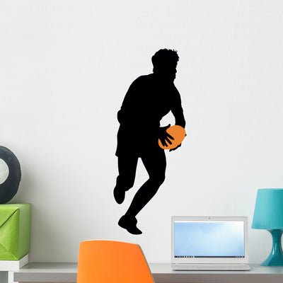 Football Silhouette Wall Decal shown on a wall