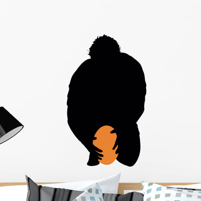 Football Silhouette Wall Decal shown on a wall