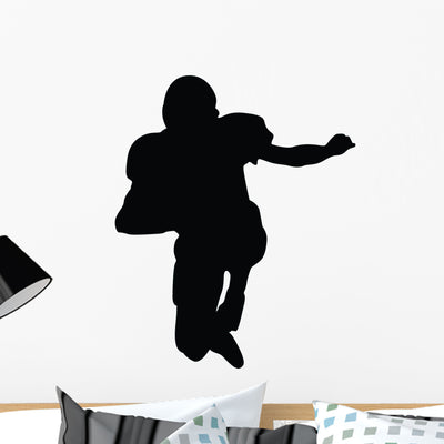 Football Silhouette Wall Decal shown on a wall