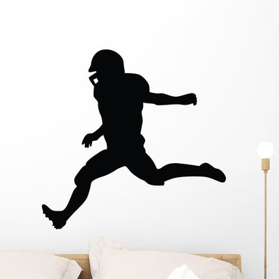 Football Silhouette Wall Decal shown on a wall