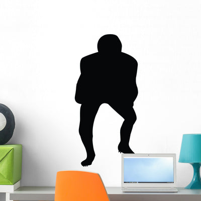 Football Silhouette Wall Decal shown on a wall