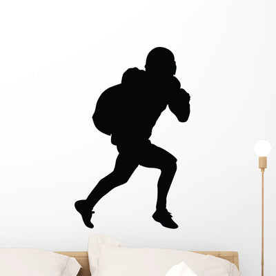 Football Silhouette Wall Decal shown on a wall
