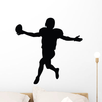 Football Silhouette Wall Decal shown on a wall