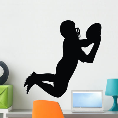 Football Silhouette Wall Decal shown on a wall