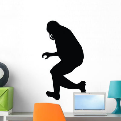 Football Silhouette Wall Decal shown on a wall