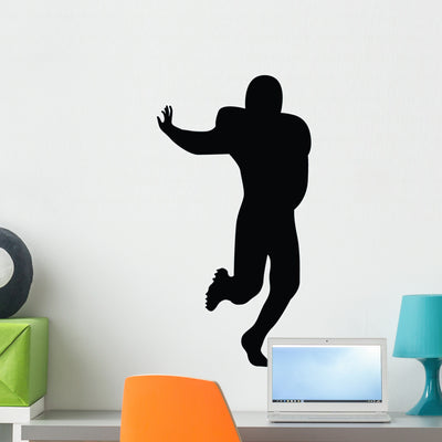 Football Silhouette Wall Decal shown on a wall