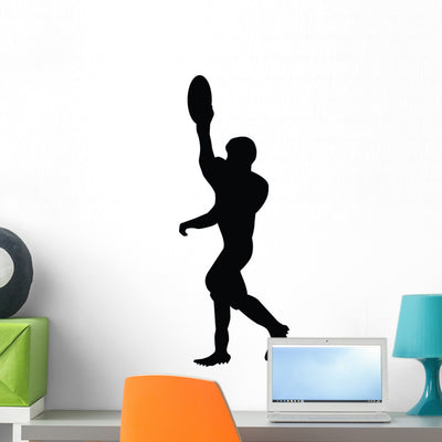 Football Silhouette Wall Decal shown on a wall