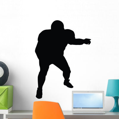 Football Silhouette Wall Decal shown on a wall