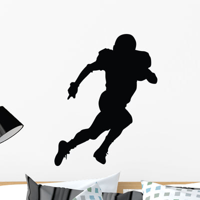 Running Football Silhouette Wall Decal shown on a wall