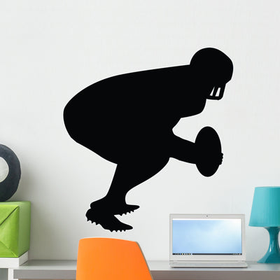 Football Silhouette Wall Decal shown on a wall