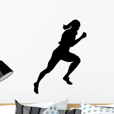 Athletic Runner Silhouette Wall Decal shown on a wall
