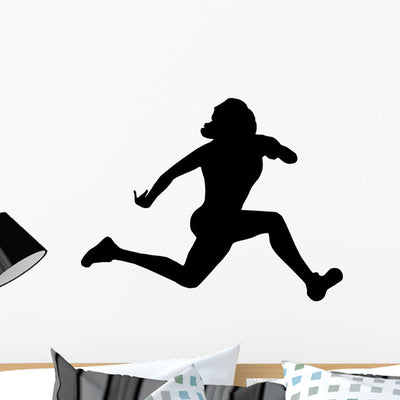 Athletic Runner Silhouette Wall Decal shown on a wall