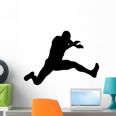 Athletic Runner Silhouette Wall Decal shown on a wall