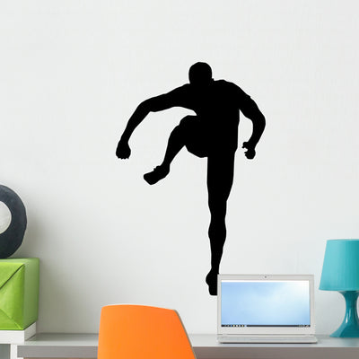 Athletic Runner Silhouette Wall Decal shown on a wall
