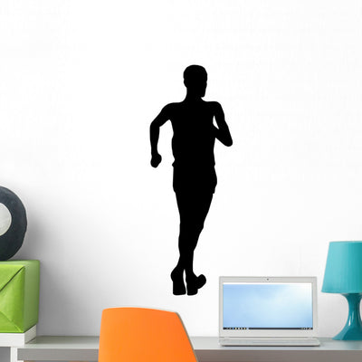 Athletic Runner Silhouette Wall Decal shown on a wall