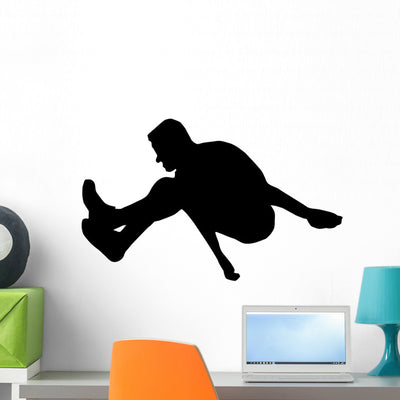 Athletic Runner Silhouette Wall Decal shown on a wall