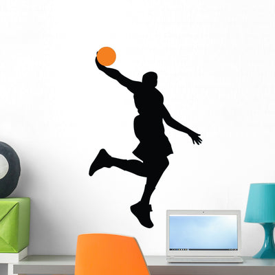Dunking Basketball Player Silhouette Wall Decal shown on a wall
