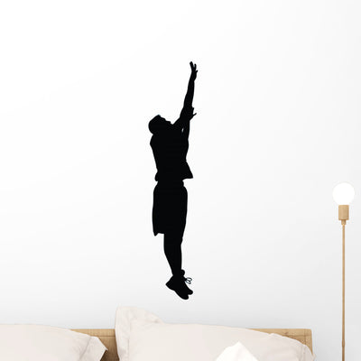 Basketball Player Silhouette Wall Decal shown on a wall