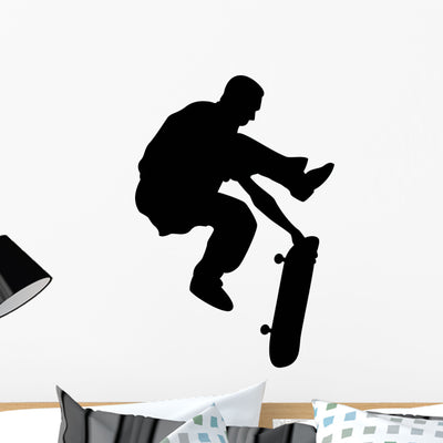 One-handed Skate Boarding Silhouette Wall Decal shown on a wall