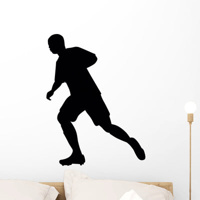Soccer Silhouette Wall Decal shown on a wall