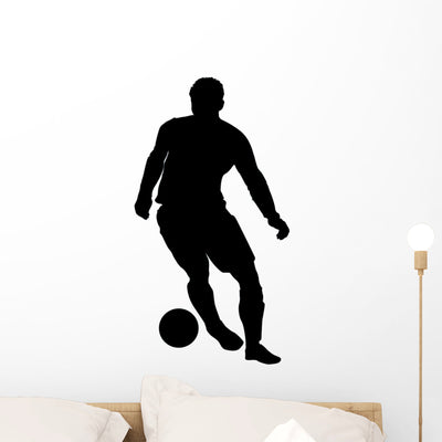 Dribbling Soccer Silhouette Wall Decal shown on a wall