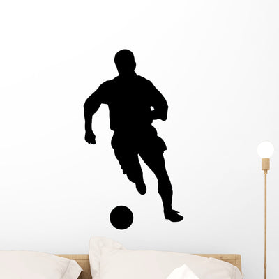 Running Soccer Silhouette Wall Decal shown on a wall