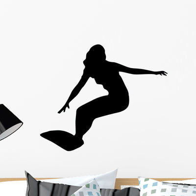 Female Surfer Surfing Wall Decal shown on a wall
