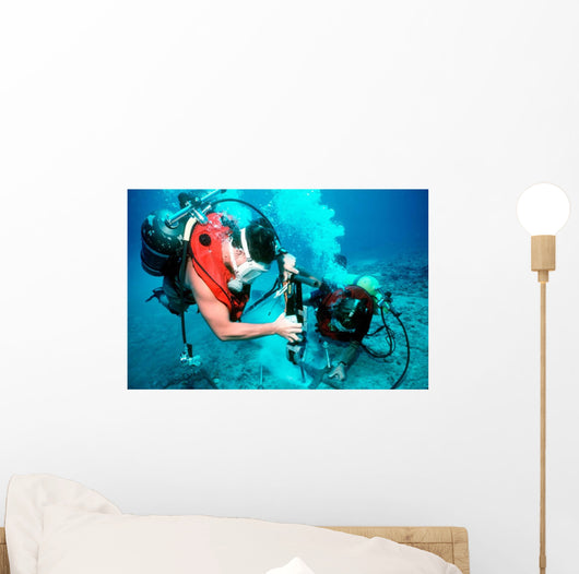 Divers Work to Repair Wall Decal