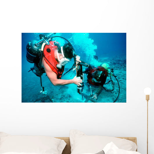 Divers Work to Repair Wall Decal