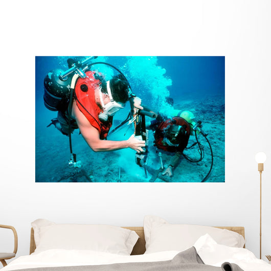 Divers Work to Repair Wall Decal