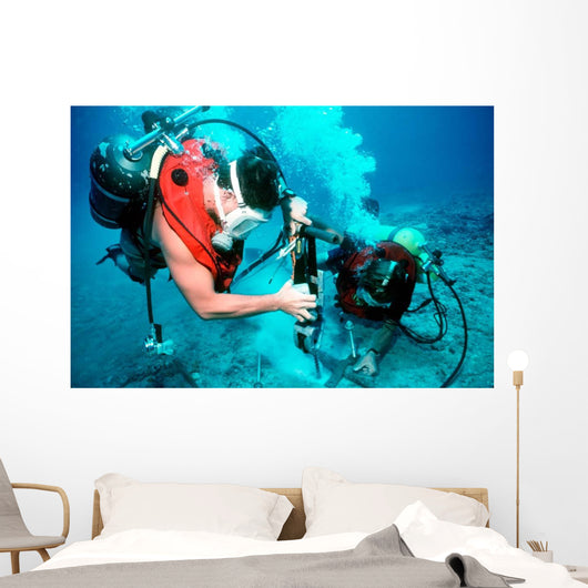 Divers Work to Repair Wall Decal