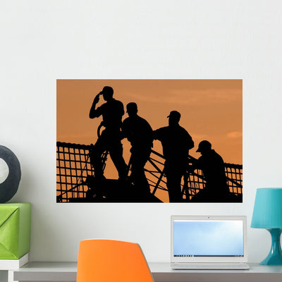 Crewmen Salute American Flag Wall Decal shown on a wall