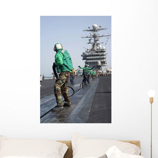 Air Department Crewmembers Remove Wall Decal