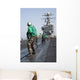 Air Department Crewmembers Remove Wall Decal