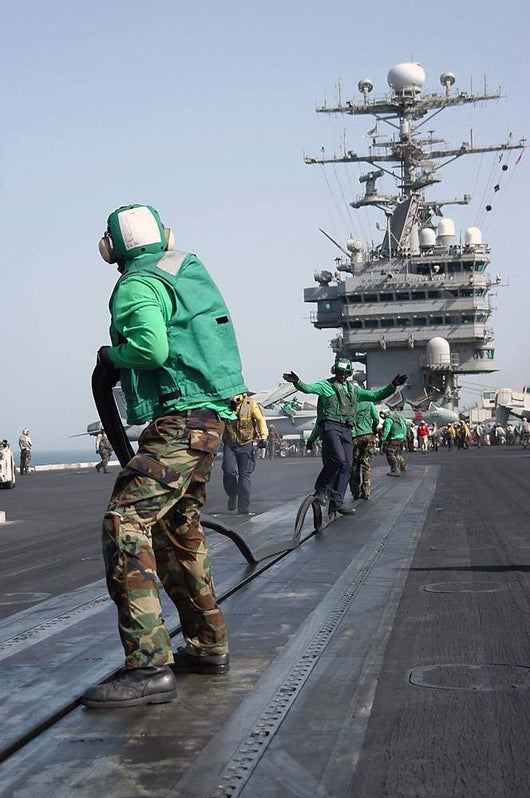 Air Department Crewmembers Remove Wall Decal
