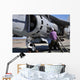 Aviation Fuel Technician Attaches Wall Decal