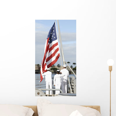 Sailors Hoist American Flag Wall Decal shown on a wall