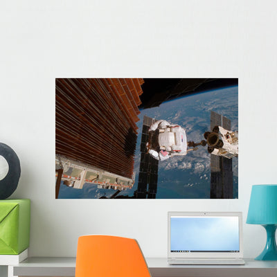 Astronaut Works with Port Wall Decal Design 2 shown on a wall